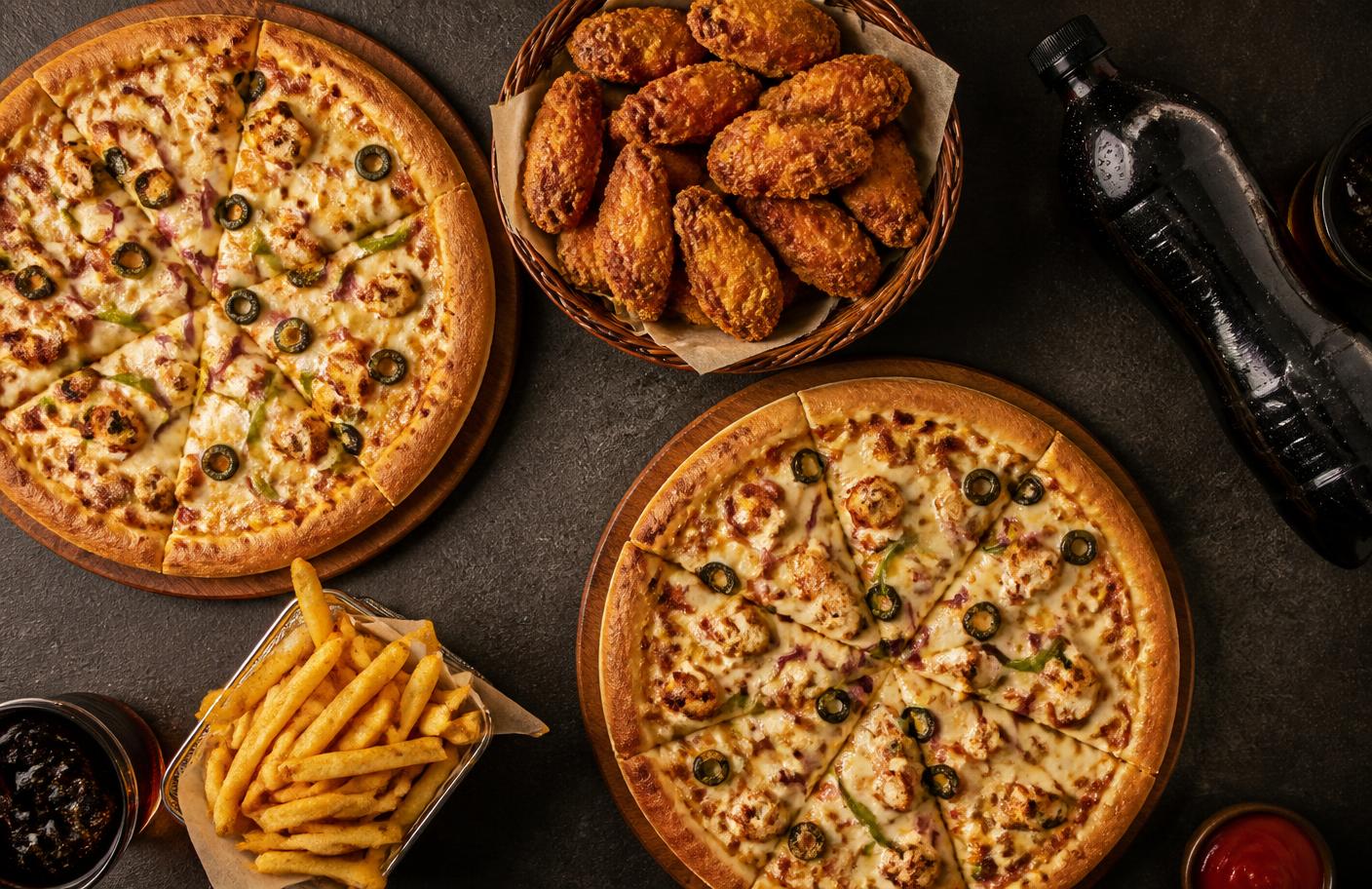 Two large Feast pizzas with a basket of wings and fries
